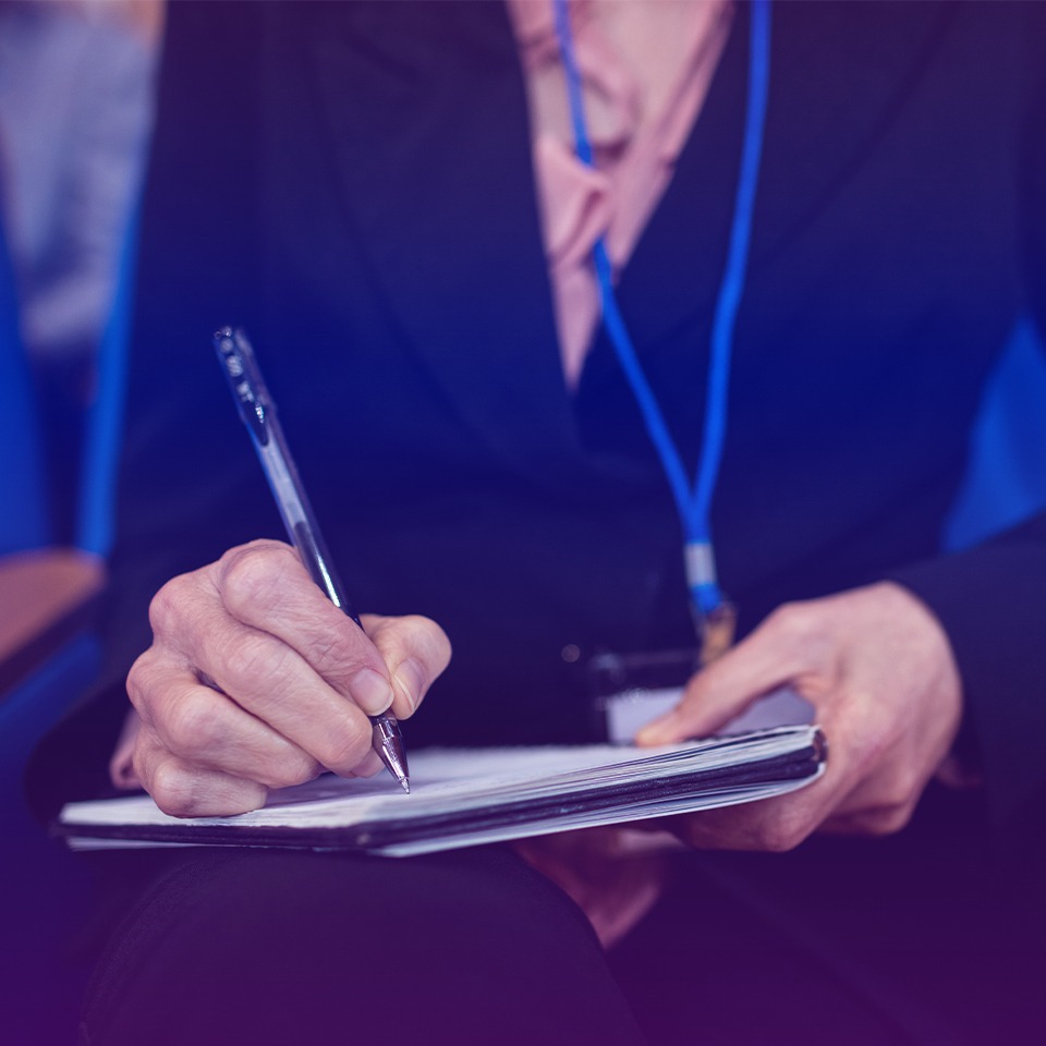 Conference attendee taking notes